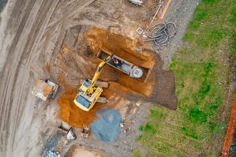 Aerial view of excavator setting trench box