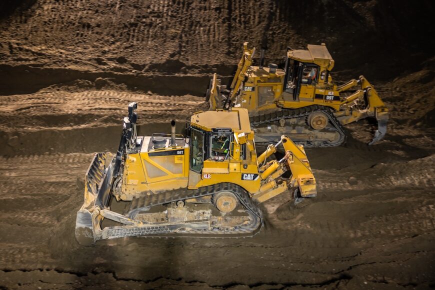 F200 two dozers working alongside each other at night