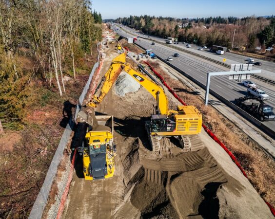F200 aerial picture of excavator loading a haul truck along I5