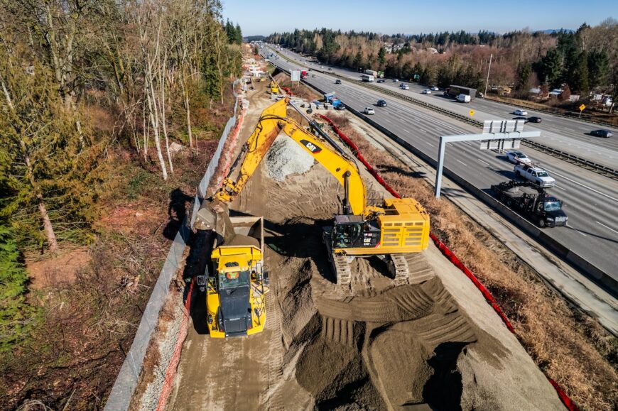 F200 aerial picture of excavator loading a haul truck along I5