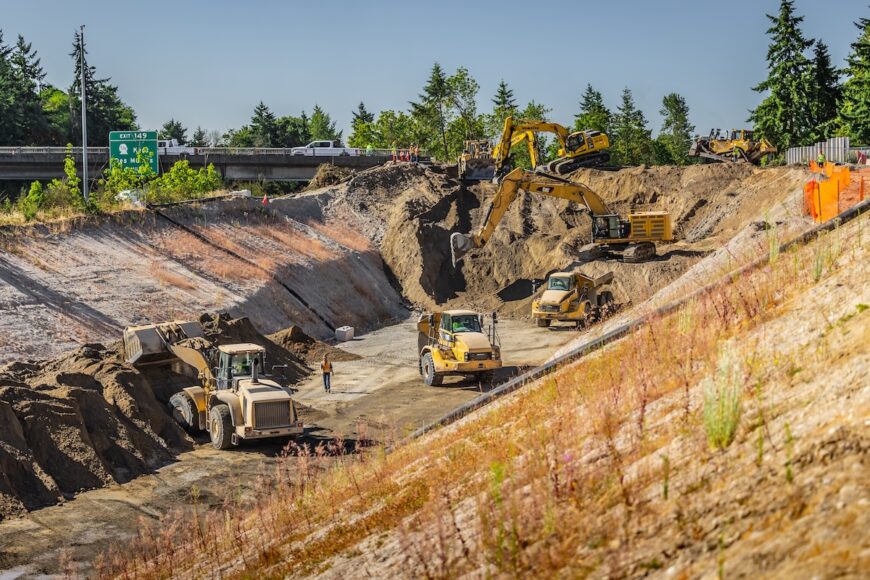 F200 multiple excavators excavating and loading haul trucks in tight area