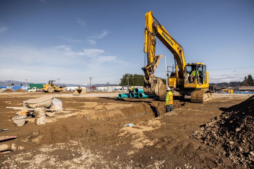 Project Roxy excavator excavating trench for pipe crew