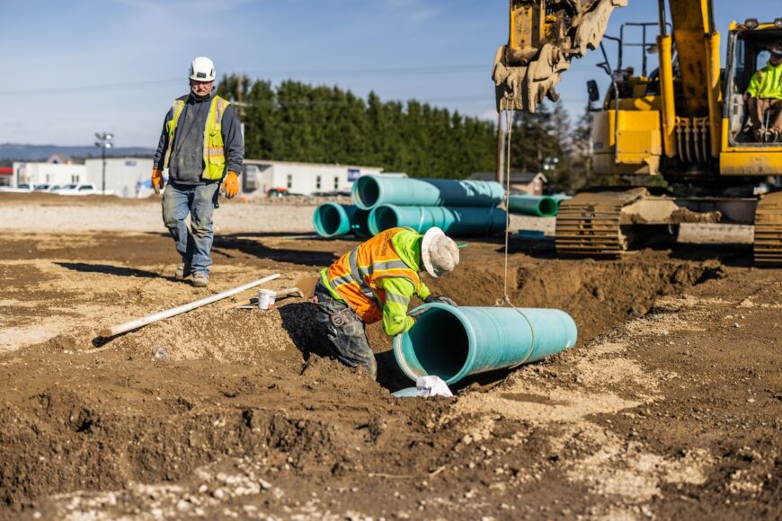 Project Roxy crew installing pipe