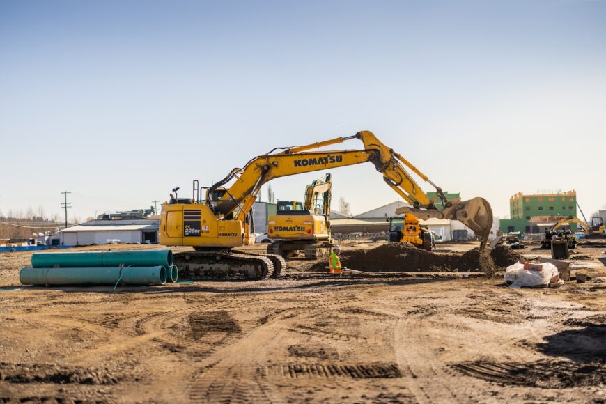 Project Roxy excavator excavating trench for pipe crew