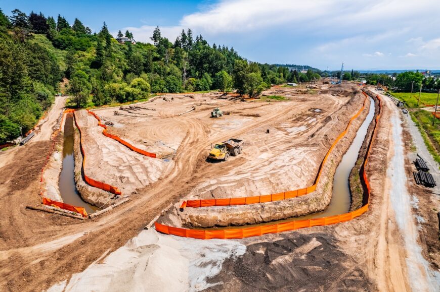 SR167 wetland mitigation. Haul truck and sheep's foot roller working onsite