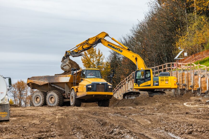 Algona excavator loading haul truck onsite