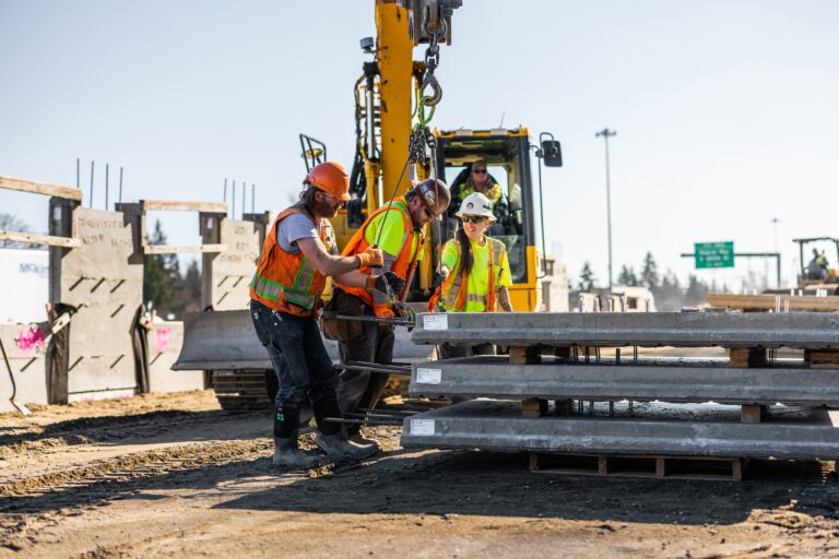 Workers securing panels for installation